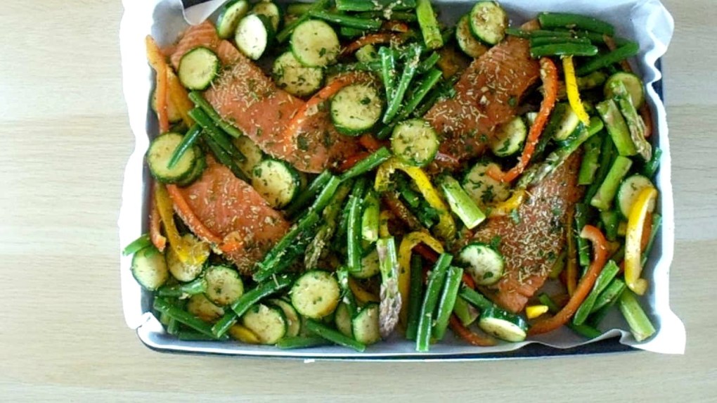 Spread the vegetables out around the salmon.
