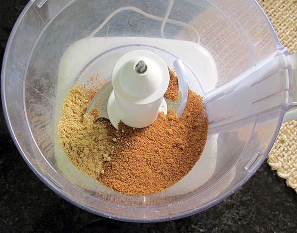 Into a food processor place, the coconut sugar and ginger.