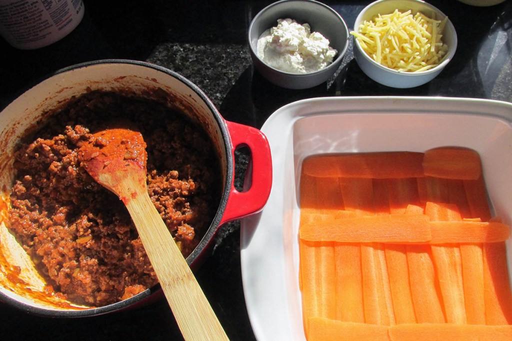 Start with a layer of carrot ribbons at the bottom of the baking dish.