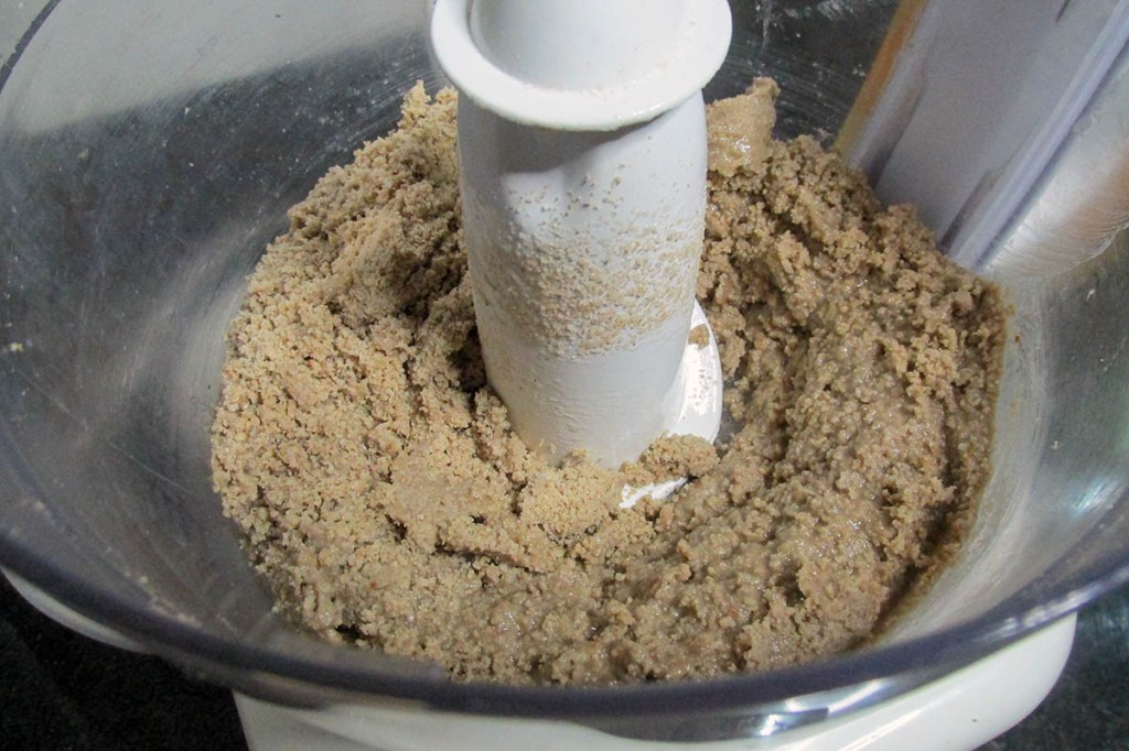 Scraping the sides of the processor down when needed.