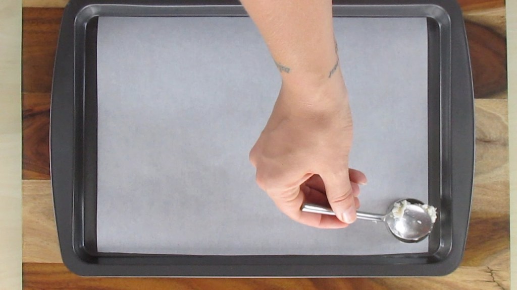 Add one teaspoon of the cookie mixture to the cookie cutter