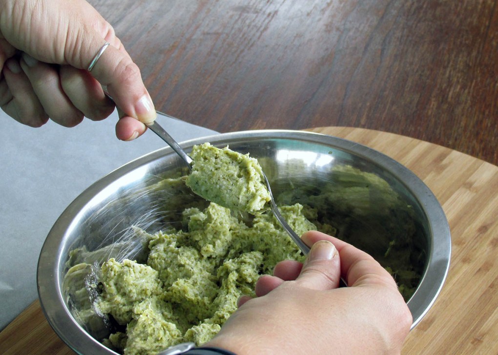 With one of the teaspoons scoop up a heaping portion of the mixture.