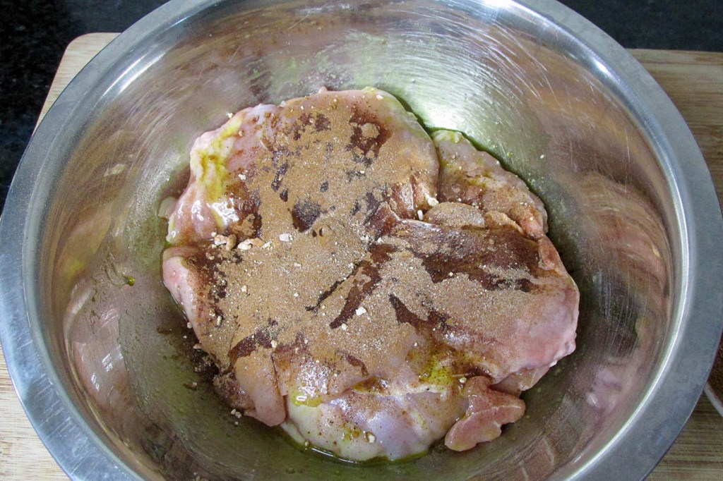 Sprinkle the spice over the chicken.