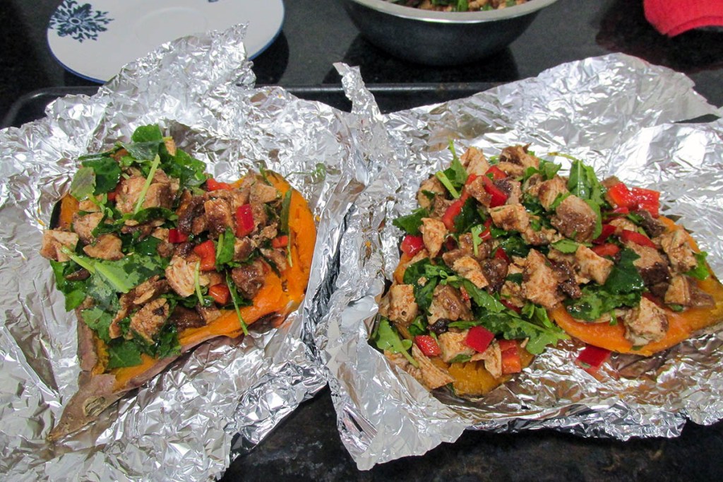 Add the chicken and kale mixture to the inside of the baked sweet potatoes.