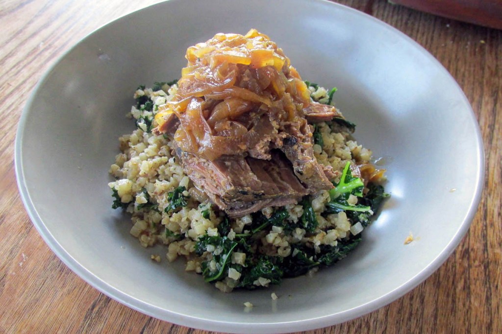 Beef and onions on a bed of cauliflower rice