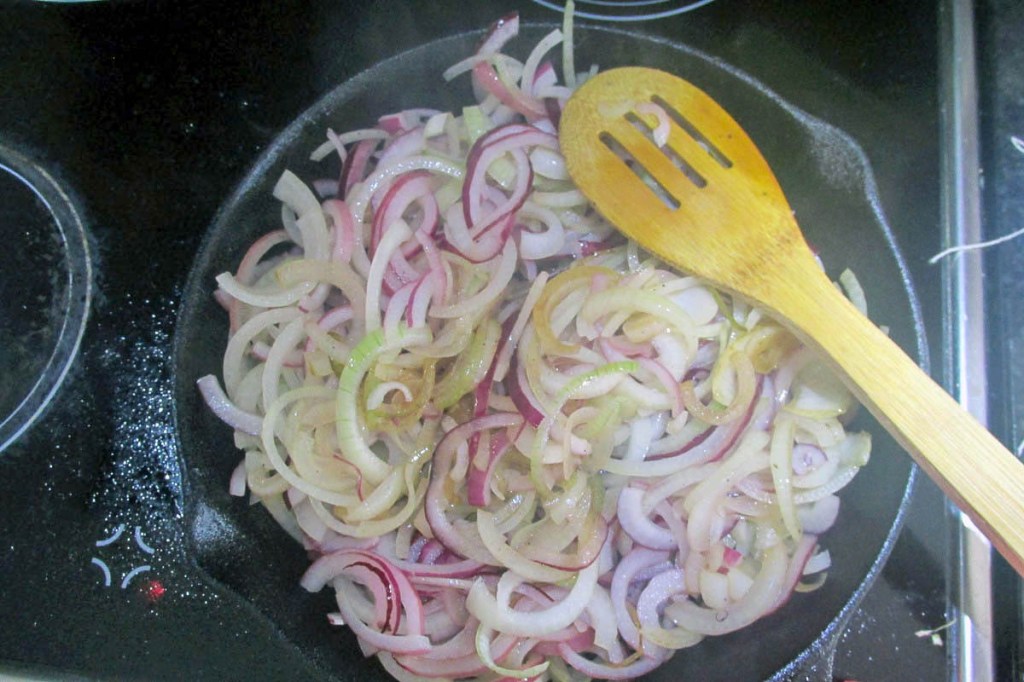 Add the sliced onions to the pan and let them cook for about 15 minutes