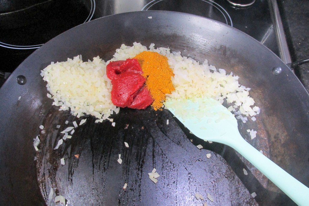Add the curry powder and tomato paste.