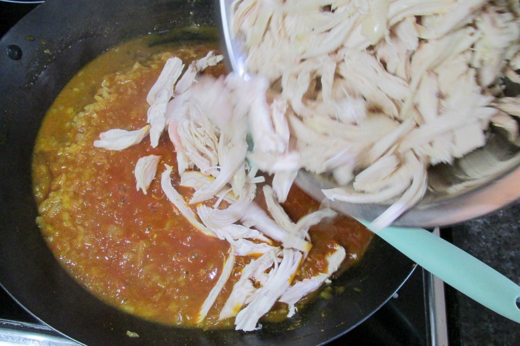 Add the shredded chicken to the pan and mix. 