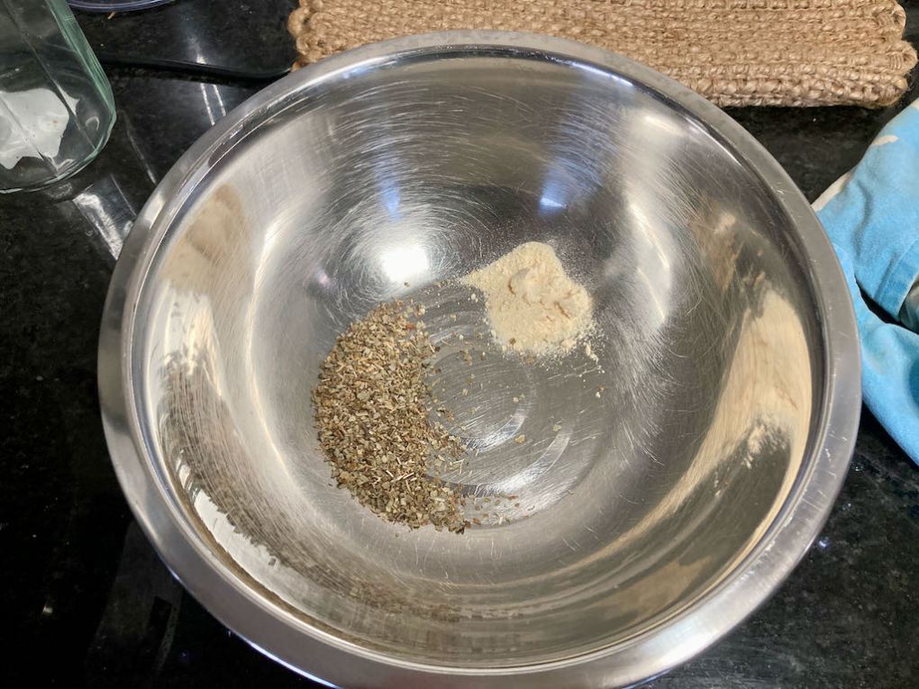 In a bowl add the garlic powder and sage.
