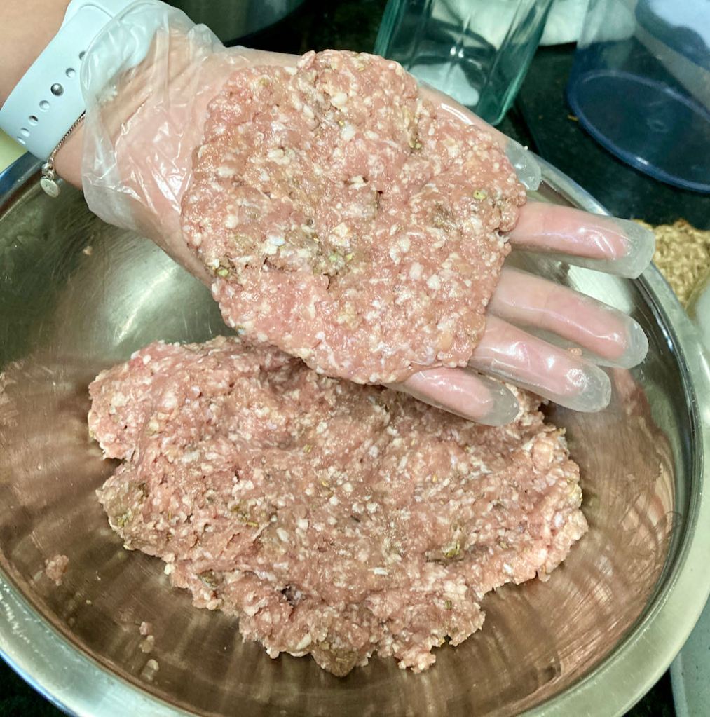 Take a portion of meat and flatten it in between your hands to make a meat patty