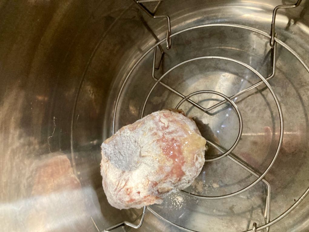 If you are using an Instant Pot place the wire rack inside the pot and put the coated eggs on the rack.