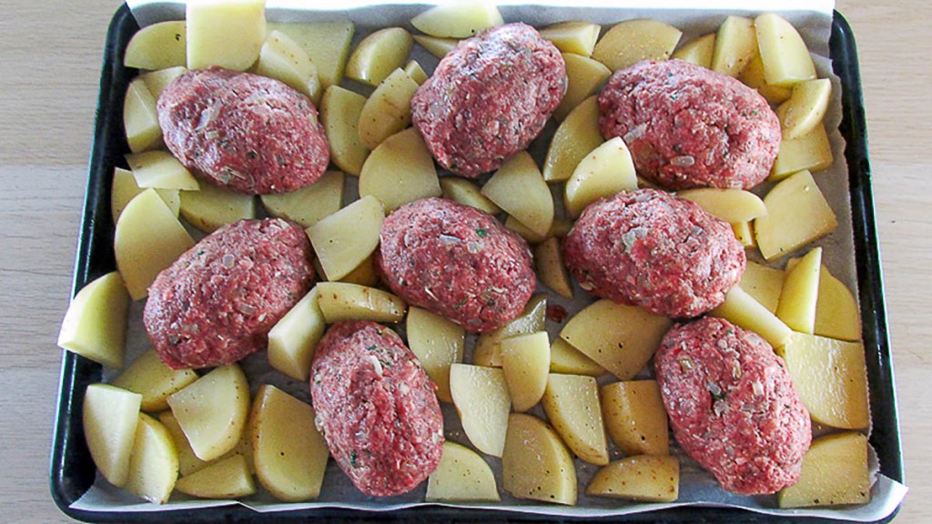 One tray mini meatloaf with potatoes ready for the oven