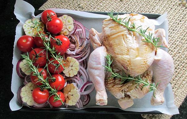 Drizzle the vinegar and olive oil over the chicken and vegetables.