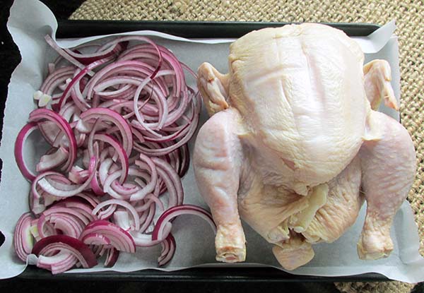 Spread out the onion next to the chicken.