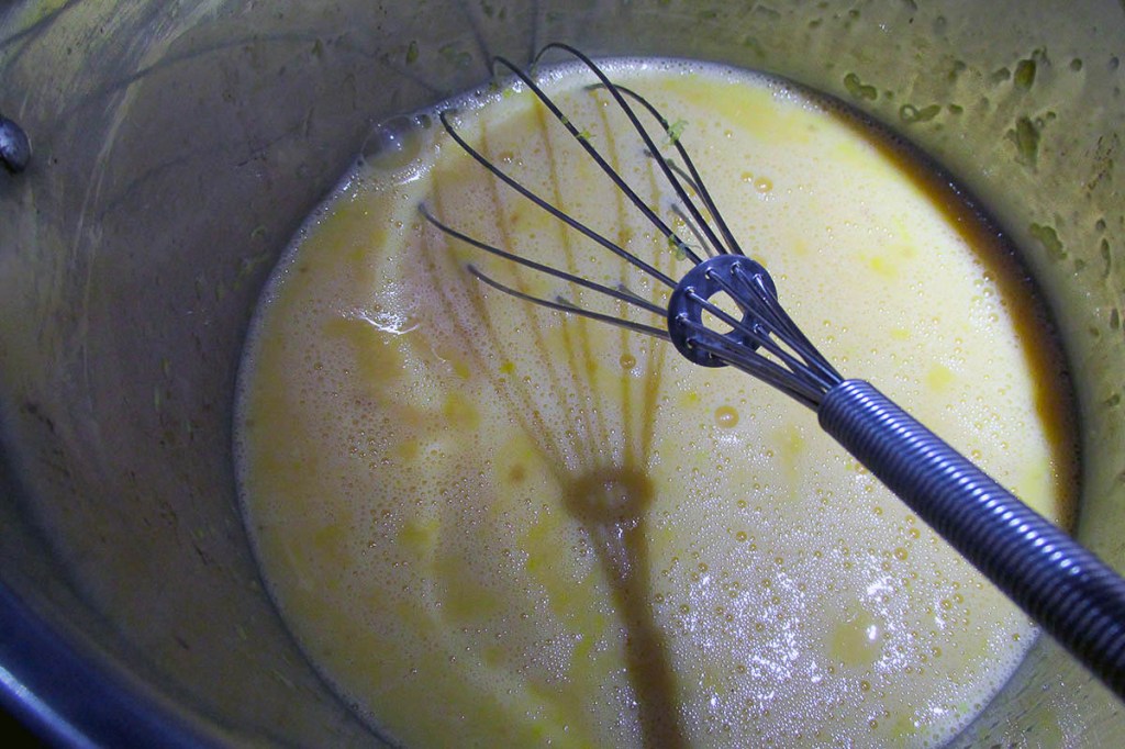 Put the eggs in the saucepan and whisk them. 