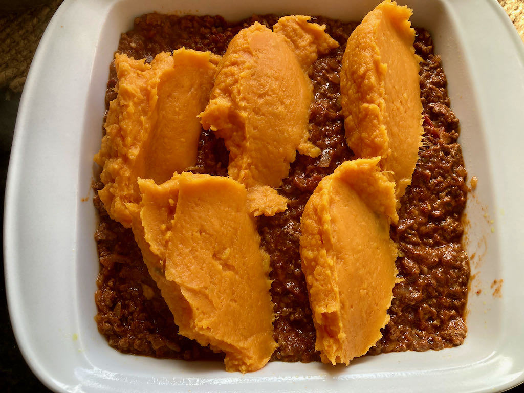 Add the sweet potato on top of the meat.