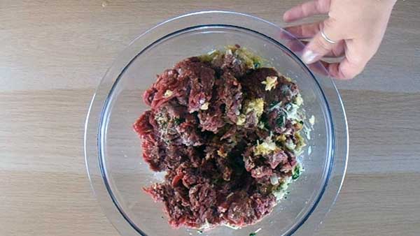 Use your hands to mix together the meat.